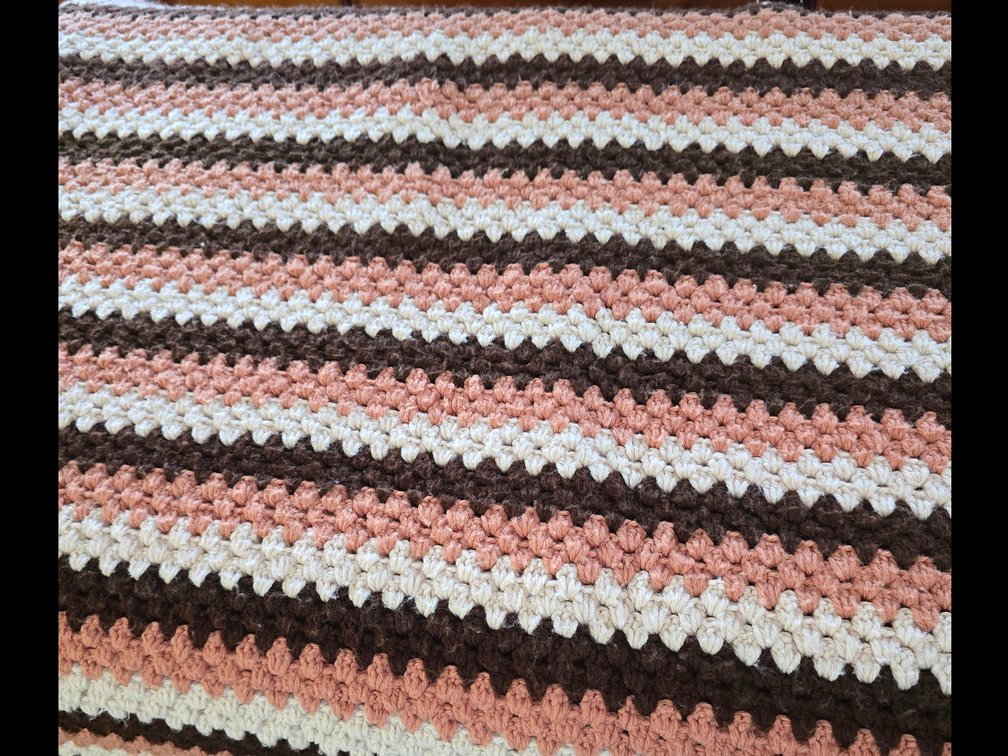 Beautiful handcrafted afghan. In tans and browns