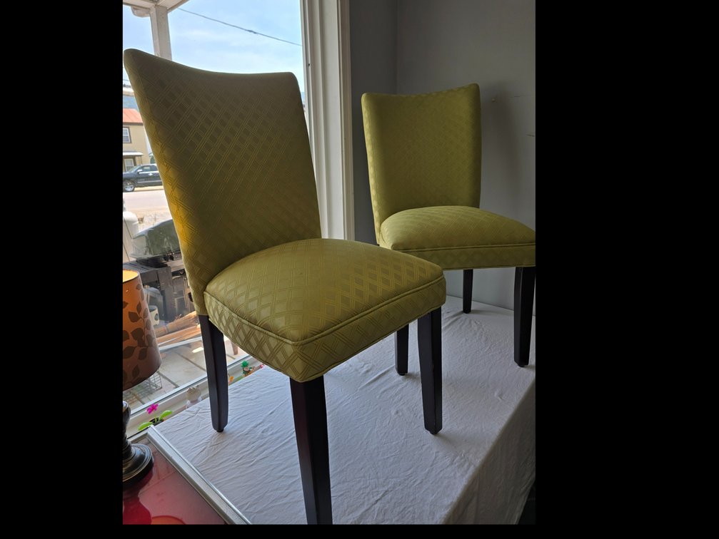 Two,  upholstered, sad chairs with wood legs in a greenish gold fabric