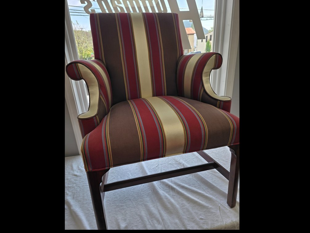 Upholstered, armchair in burgundy's browns, creams ect. 