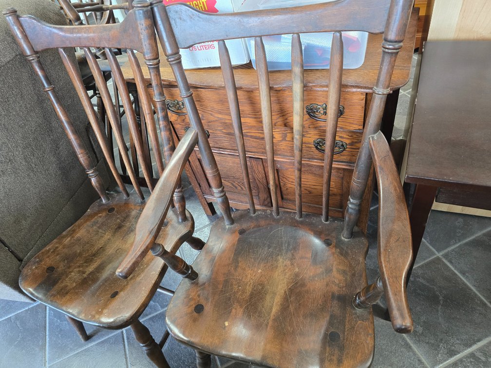 Six heavy wood chairs, two are captain chairs