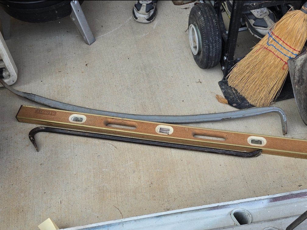 Stanley level and two crowbars