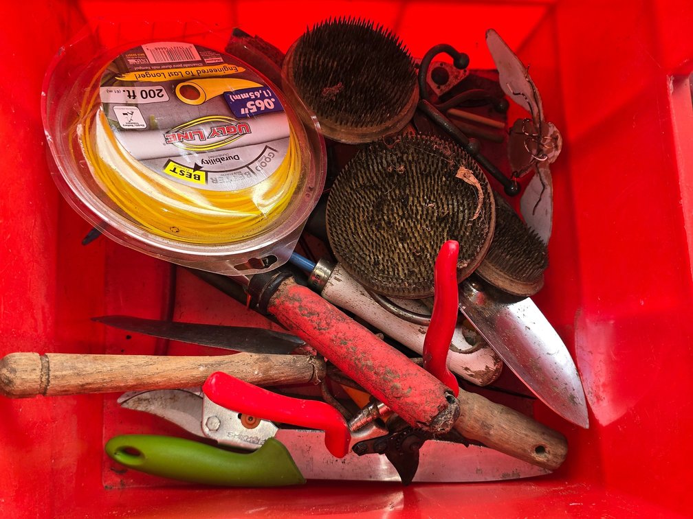 Tote with gardening tools including three frogs