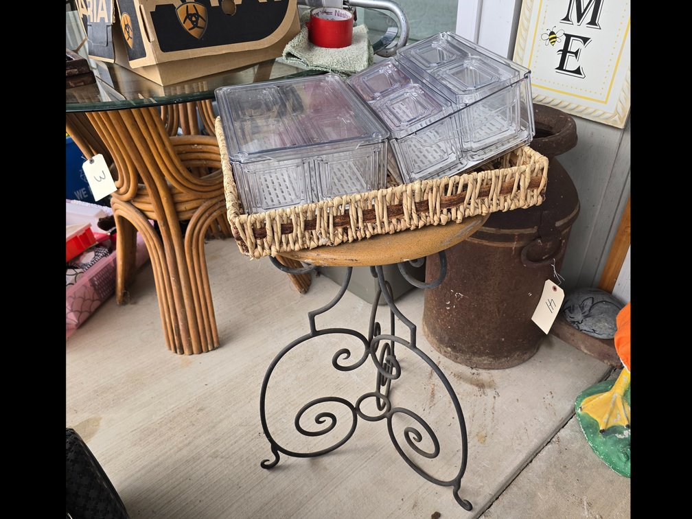 Ornate small porch table with refrigerator storage containers in a serving basket