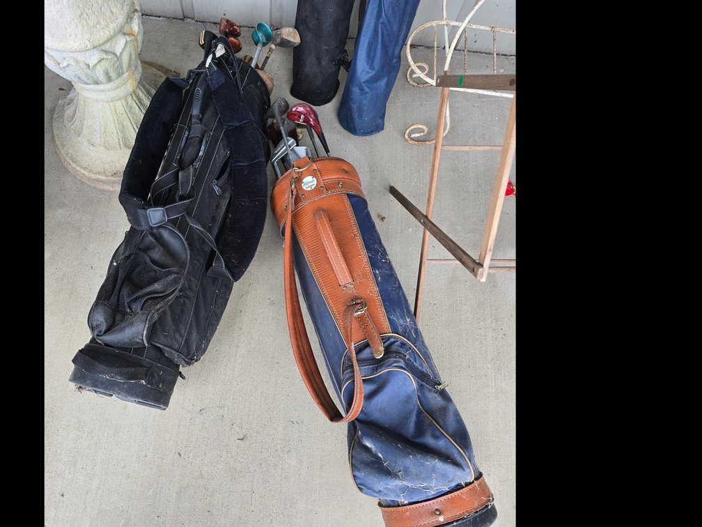 2 golf bags and misc clubs