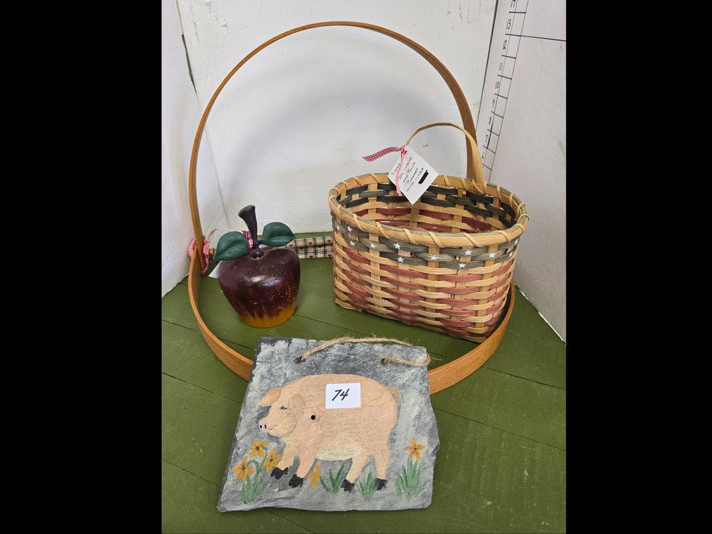 Art and craft items, including red, white, and blue basket, slate with primitive pig and cast iron apple doorstop