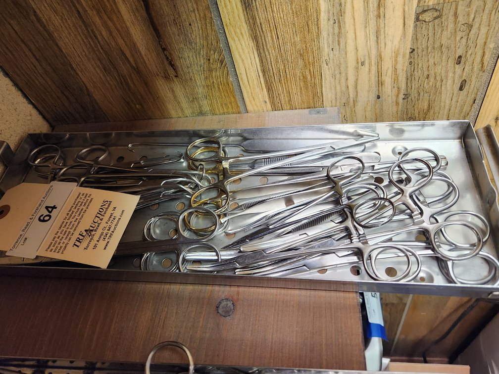 Surgical instruments in autoclave tray