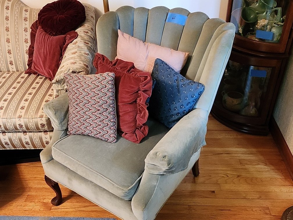 Upholstered chair with pillows