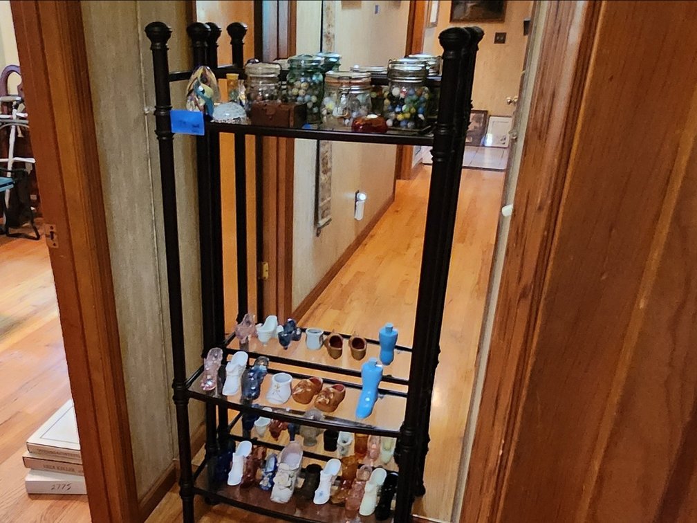 Metal shelf unit with glass shelves. 