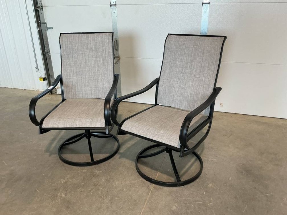 2 Swivel Patio Chairs With Black Frames and Gray Cushions