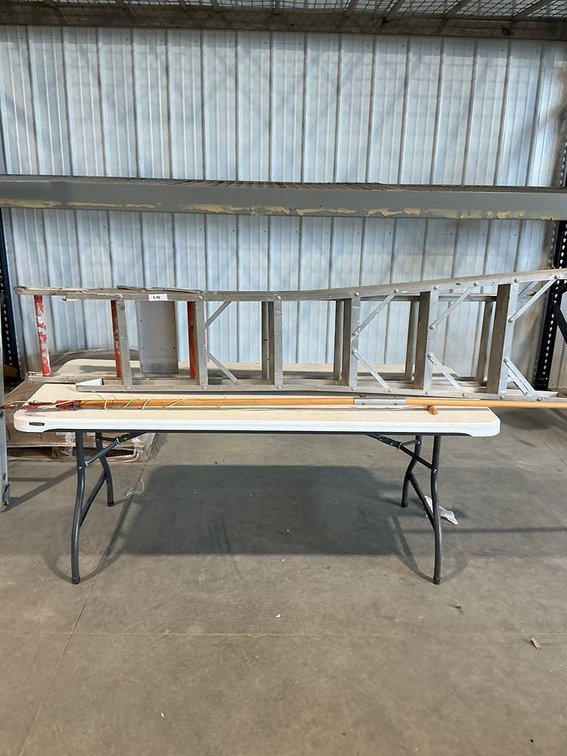 This lot includes a 6 1/2 aluminum extension ladder and a  7ft limb pruner/lobber