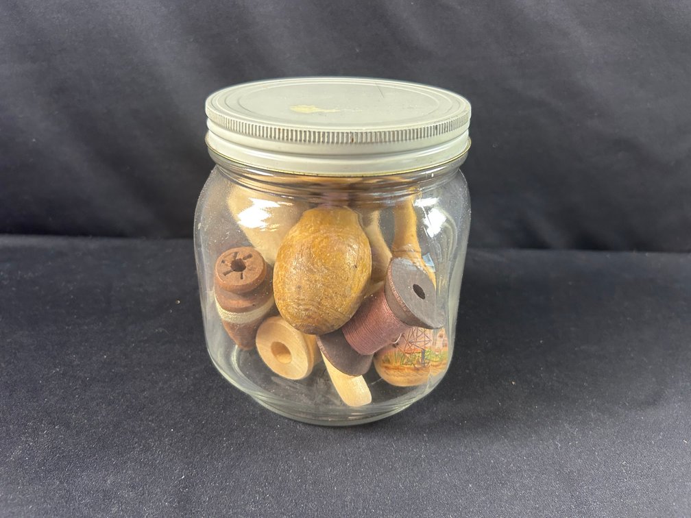 Jar with Sock Darners and Wooden Spools