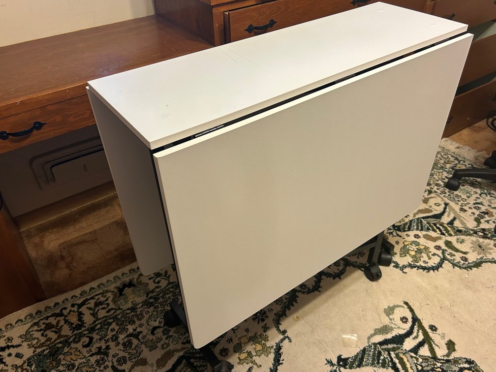 Fold Down Sides Craft/Sewing Table on Rollers.  Excellent condition.