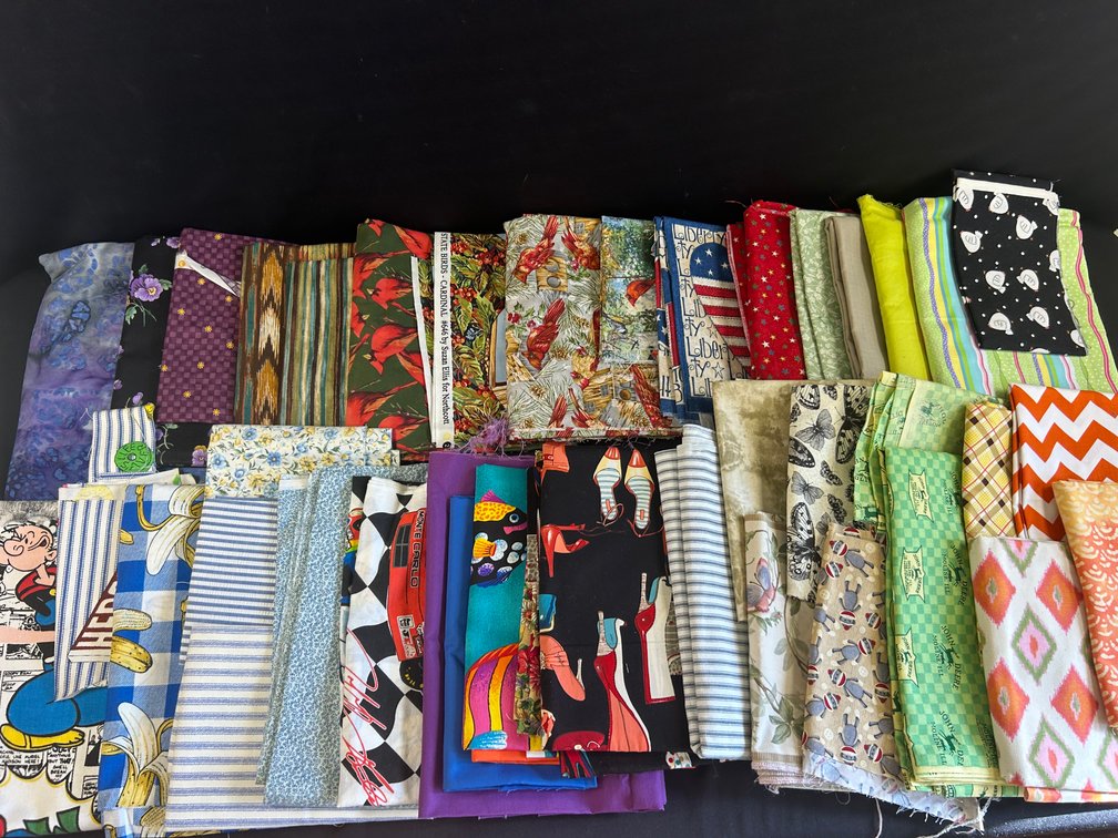 Variety of Fabric in Green Plastic Tote