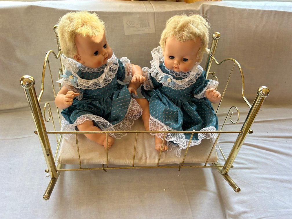 Two Vinyl Baby Dolls with Brass-Tone Metal Cradle