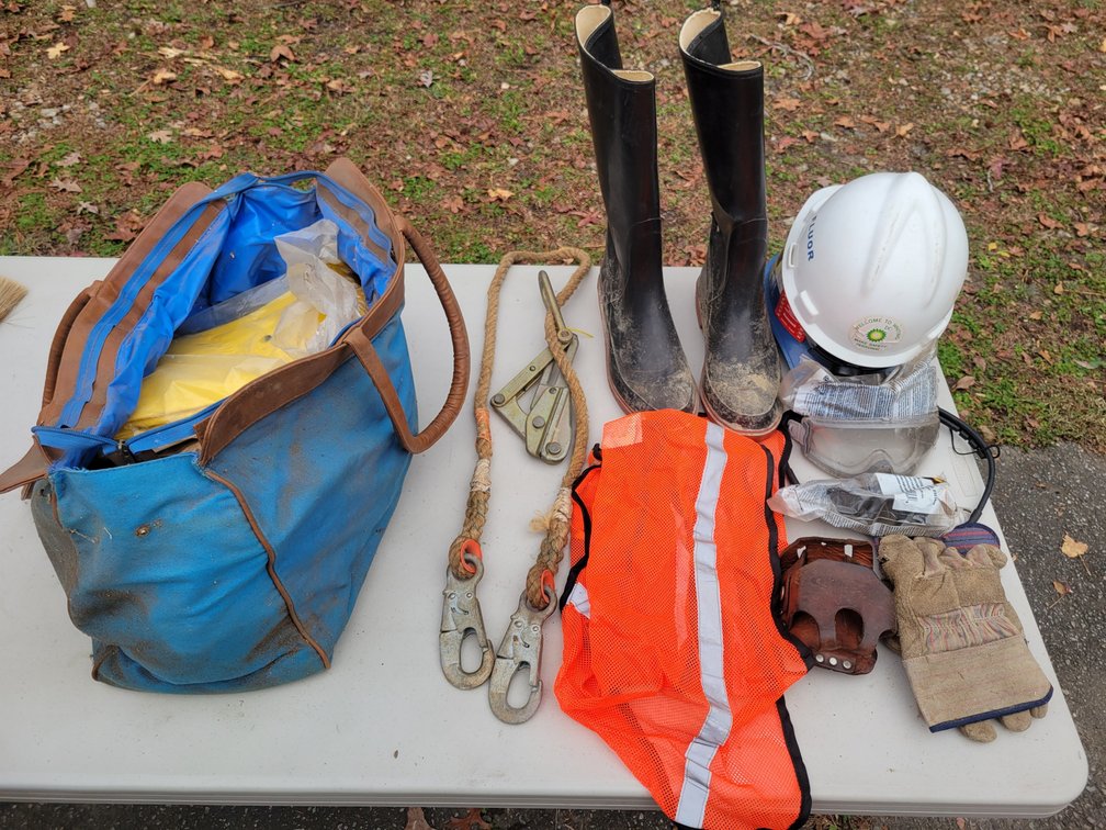 Klein Tools Cable Puller, Canvas Bag of Work Gloves, Hard Hats, Protective Glasses, Rain Jacket, Rain Boots