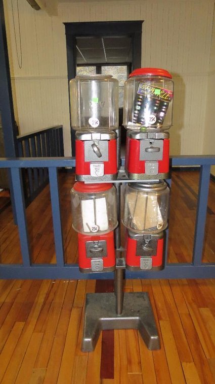 Quadruple candy dispenser mounted on a floor stand