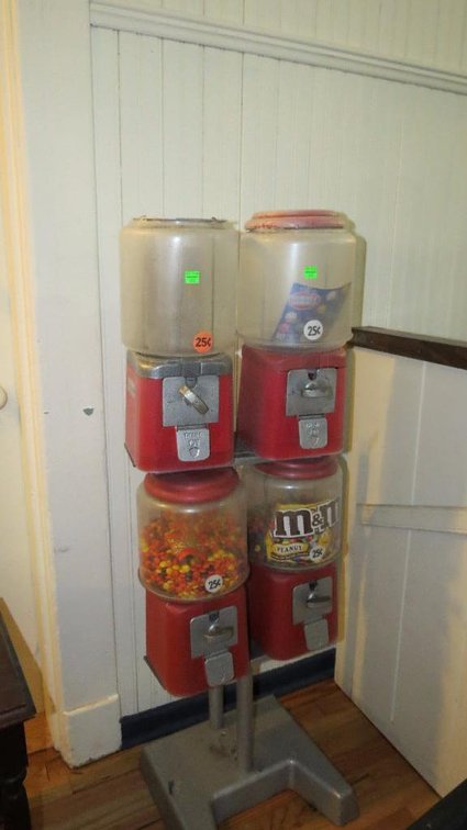 Quadruple candy dispenser mounted on a floor stand