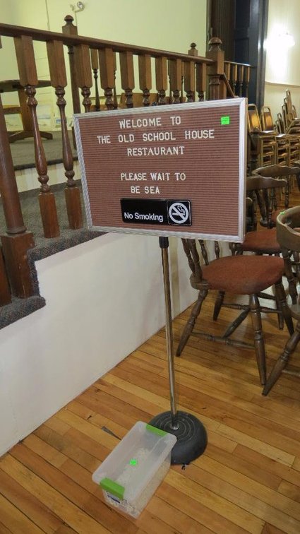 Message sign with ladders on a cast iron floor stand