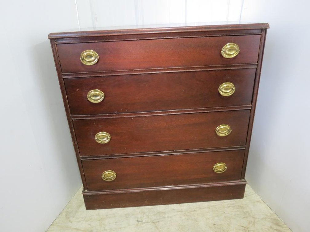 One of 2 mahogany four drawer chests with brass pulls.