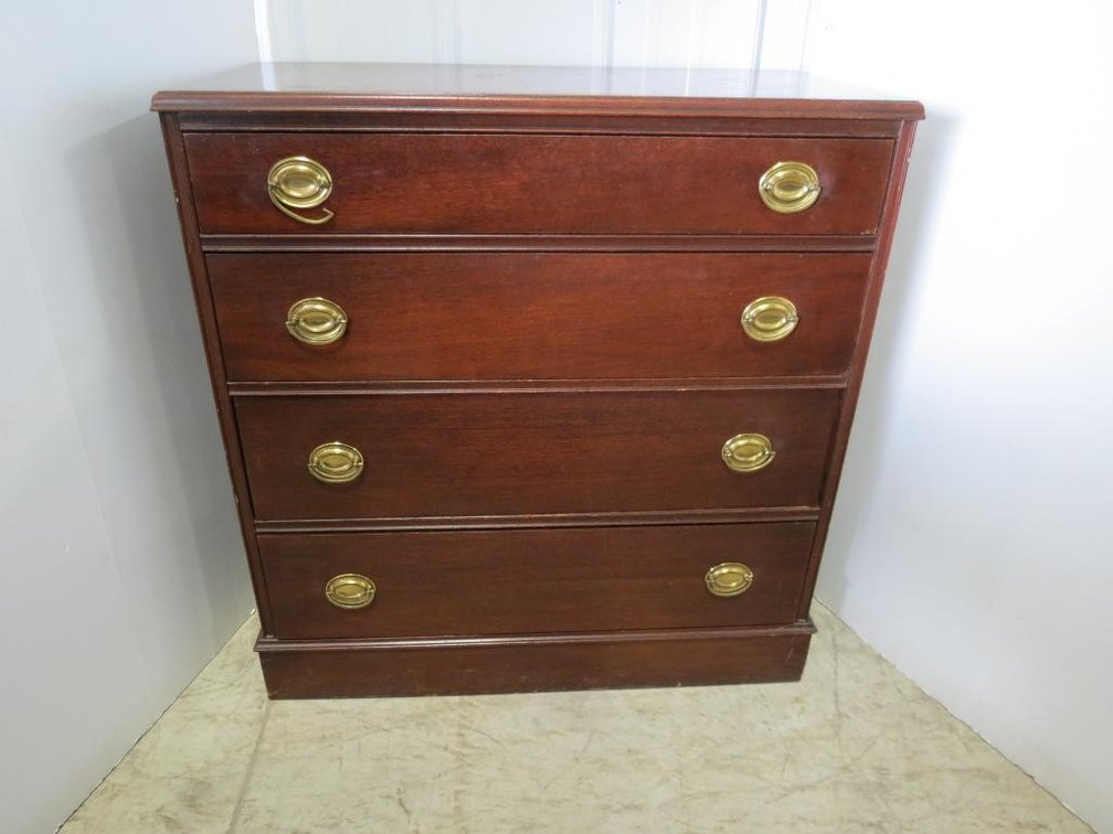 A mahogany four drawer dresser with brass pulls.