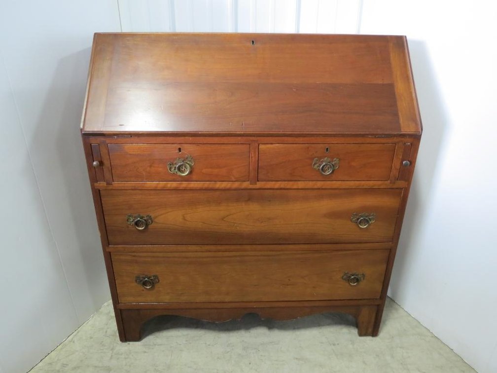 A vintage secretary desk with bat wing pulls and dovetail construction.