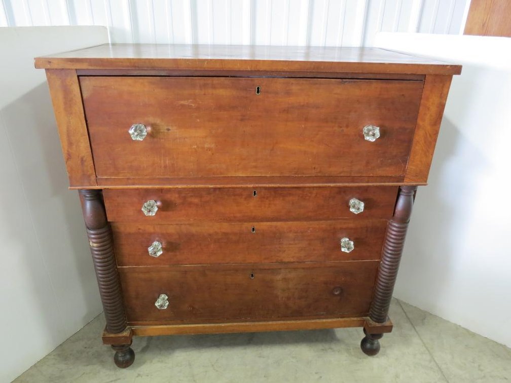 A vintage dresser with glass pulls, four drawers, and dovetail construction. Please preview for condition.