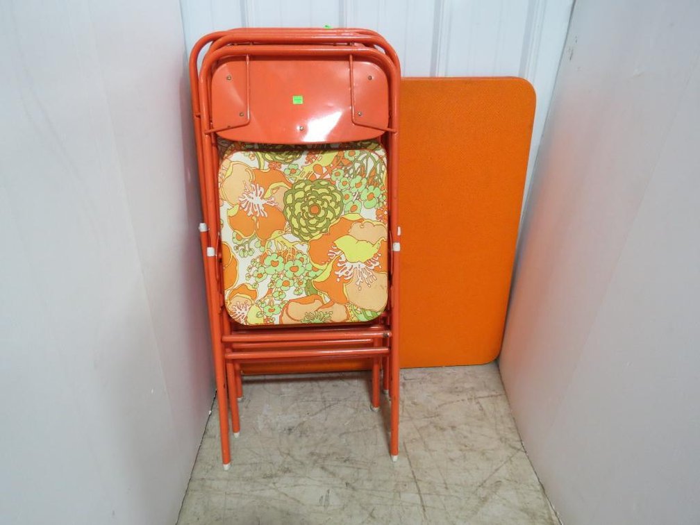 A vintage Samsonite card table (not shown) with four folding chairs in matching design.