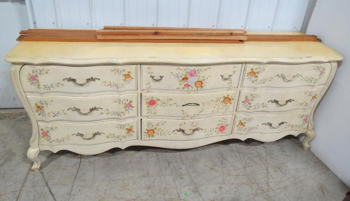 A yellow Romweber dresser with painted flower details