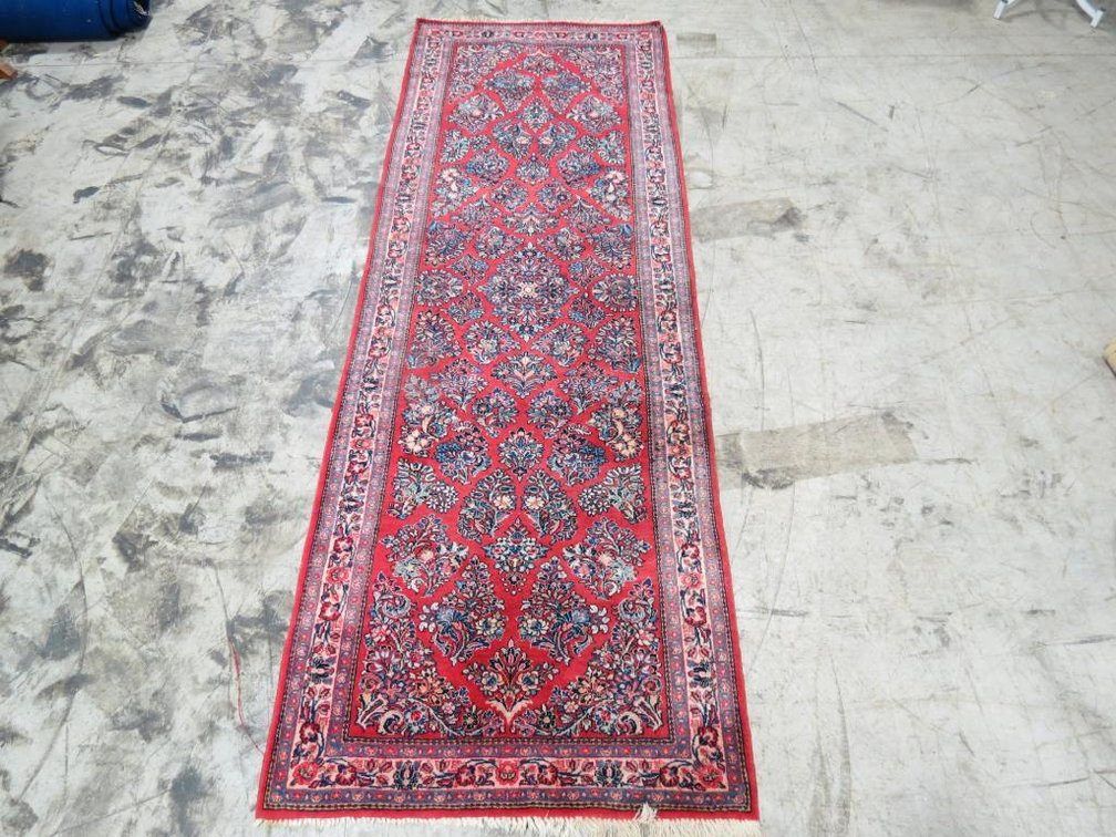 From Iran, a wool rug with label