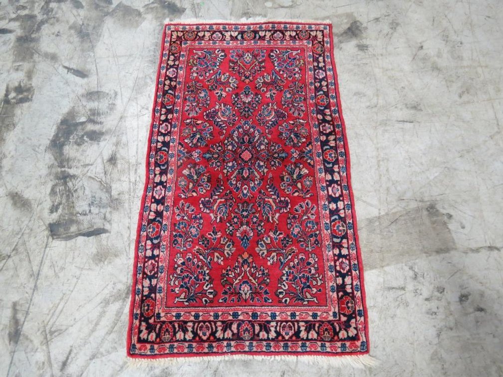 A small wool woven rug imported from Iran.