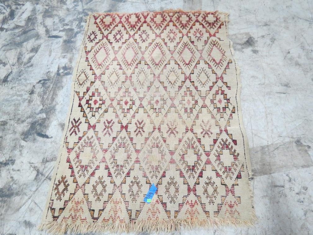 A hand loomed wool tribal rug.