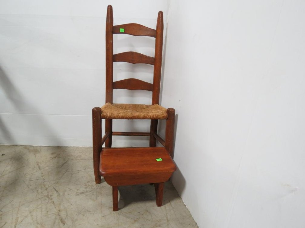 A childs vintage wooden ladder-back chair with rush seat and wooden footrest.