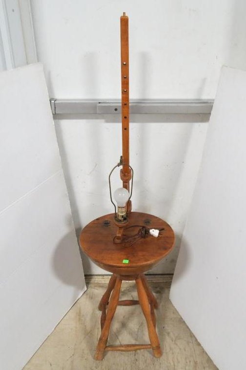 A lamp with adjustable arm and lidded bowl.