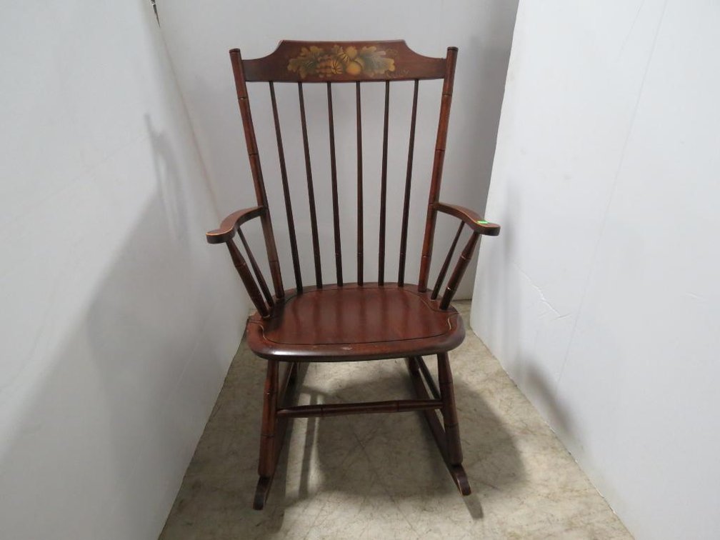 A Hitchcock rocking chair with stenciled flowers.