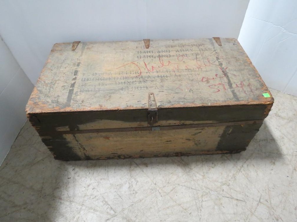 A vintage military trunk dated 1943 with Oakland Army Base painted on the top.