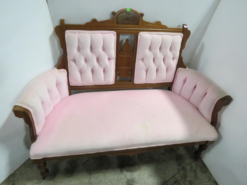 An Eastlake settee with velveteen upholstery.
