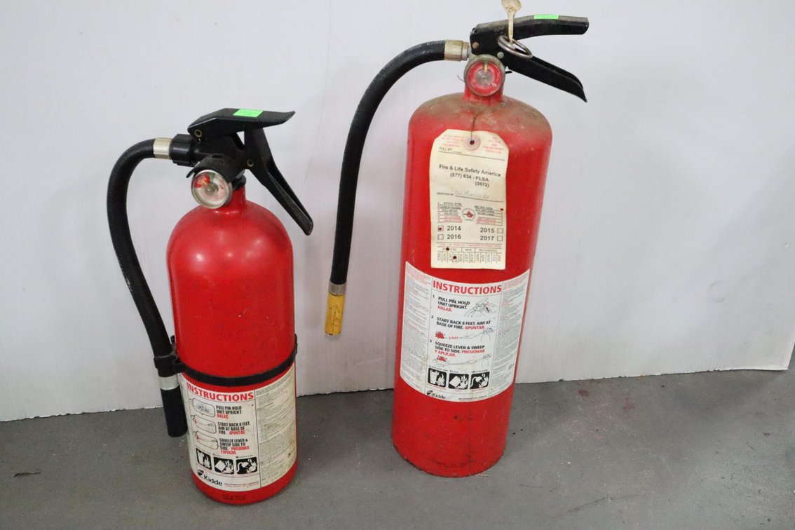 Pair of Fire Extinguishers, Smaller One Is Empty