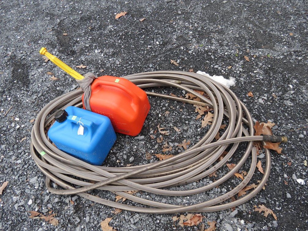 Garden Hose and Pair of Gas Cans