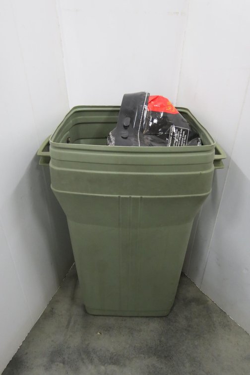 Two Bags of Charcoal Briquettes and Plastic Trash Can