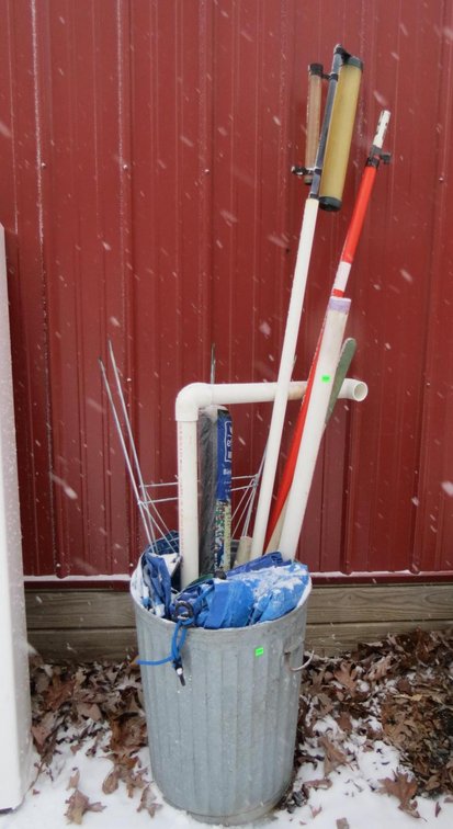 Metal Trash Can With Tarps and Outdoor Items