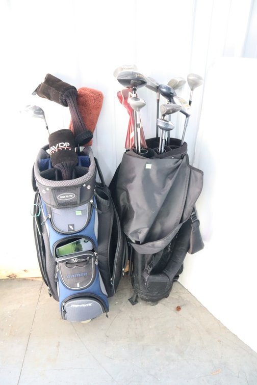 Pair of Golf Bags With Golf Clubs