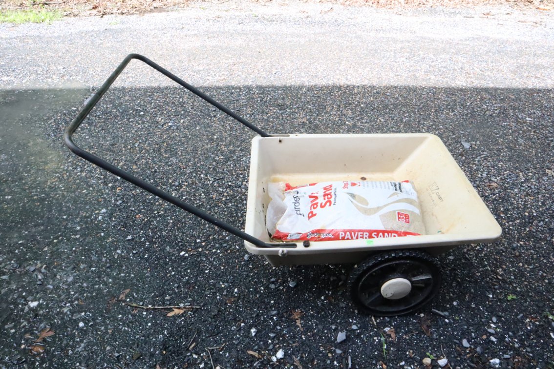 Plastic Utility Cart and Bag of Paver Sand