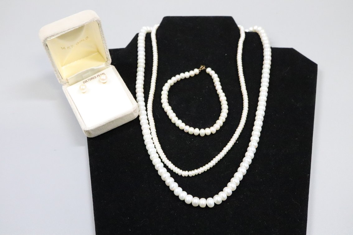2 White Cultured Pearl necklaces with 10k and 14k clasps, 1 white cultured pearl bracelet with 10k clasp, 1 set of cultured pearl stud earrings with 14k posts