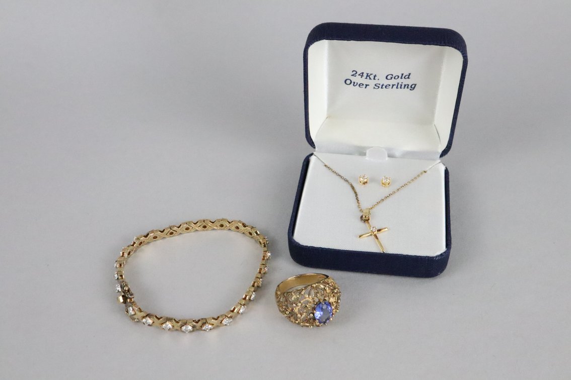 24k gold over Sterling Cross with white stone and matching stud earrings, 925 with gold color overlay tennis bracelet with white stones, 925 with gold color overlay ring with purple stone