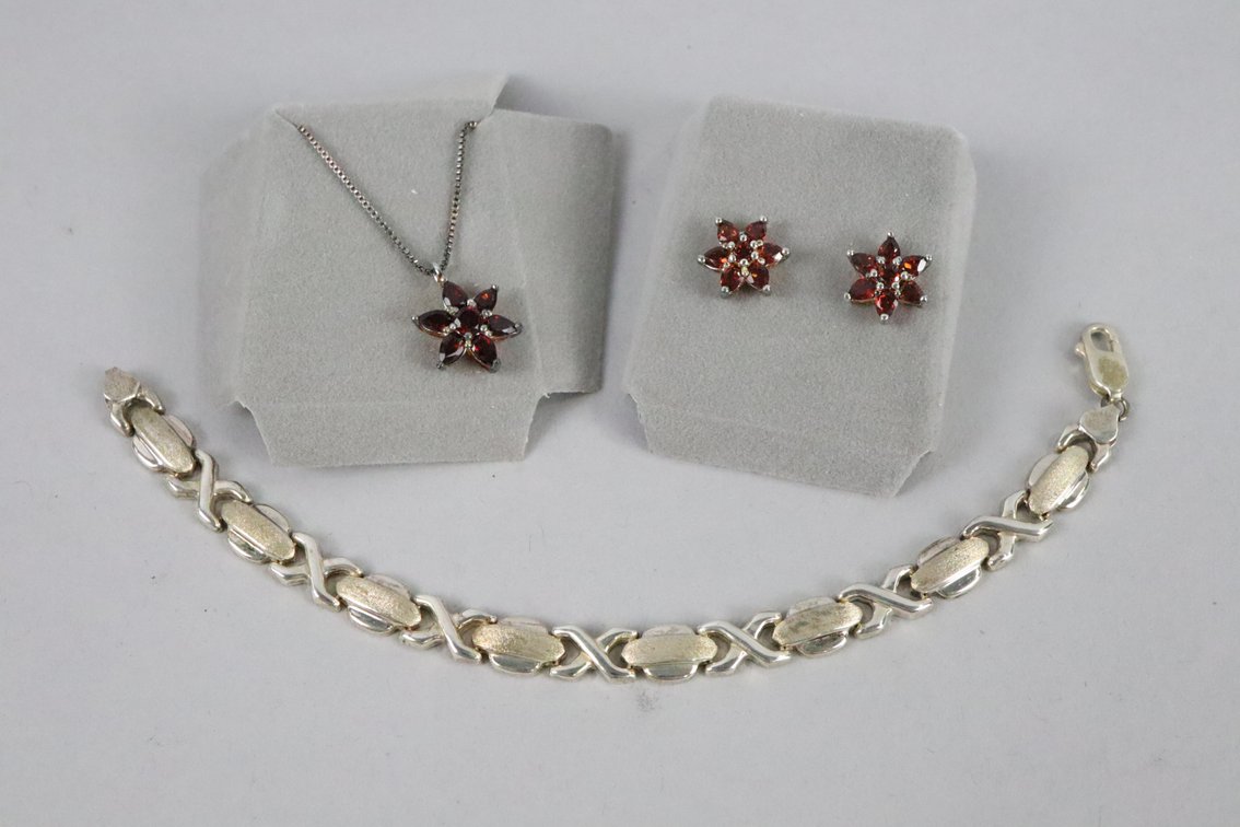 SS star pendant on chain with garnet colored stones, SS star earrings with garnet colored stones, SS bracelet