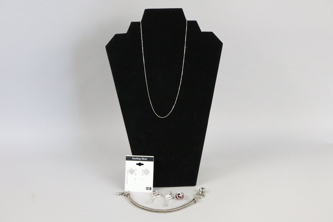 SS 18" box chain, SS heart pendant with ruby colored stone and white stones, SS blue topaz earrings, two SS key pendants, SB silver bracelet with blue stones on toggle clasp