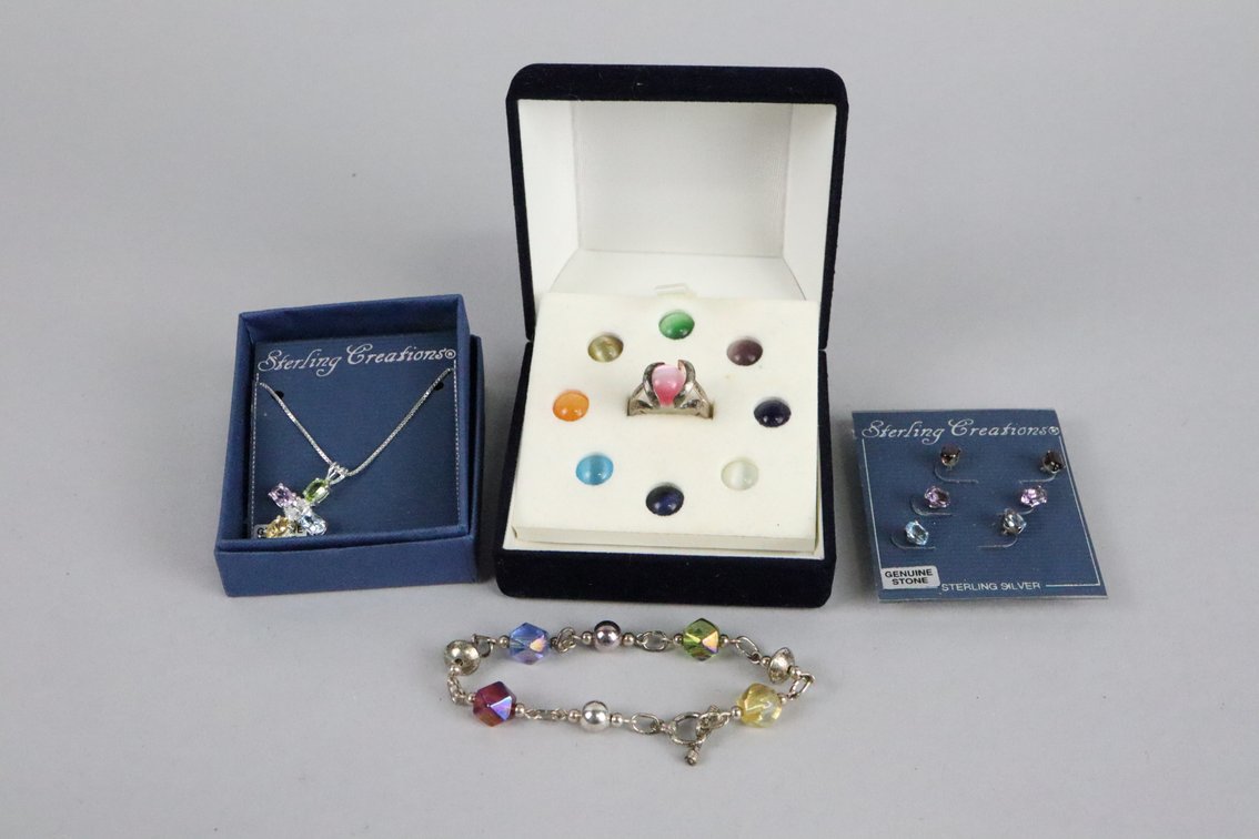 SS set of 2 gen stone stud earrings, SS size 7 ring with 9 interchangable stones, SS cross pendant with genuine stones, SS toggle bracelet with multi colored beads
