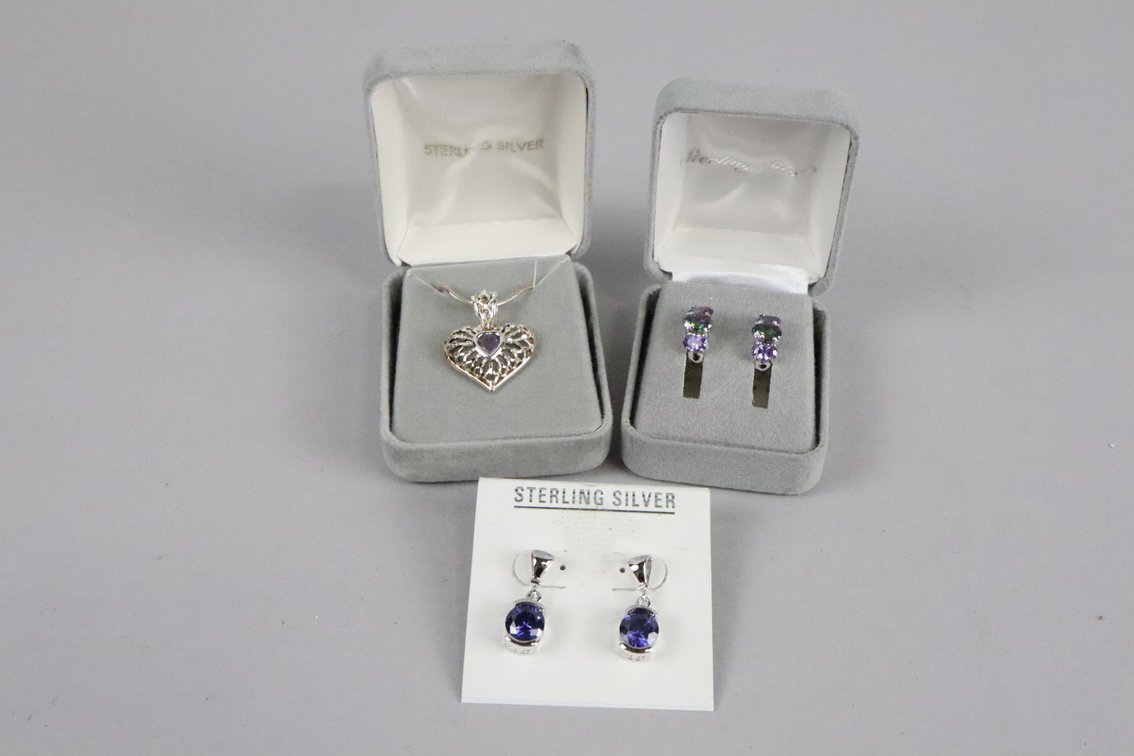 SS heart pendant with heart shaped purple stone, SS leverback earrings with purple and irridescent stones, SS dangle earrings with purple cubic zirconias