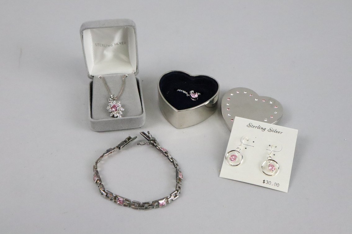 SS tennis bracelet with pink square cut stones, SS heart shaped pink cubic zirconia pendant on chain, SS dangle earrings with pink stone, SS pendant with pink and white stones