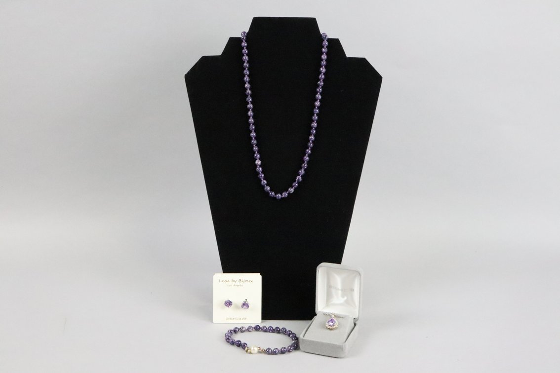 18" knotted purple beaded necklace with matching bracelet, SS purple stone teardrop pendant with white accent stones, SS purple stud earrings